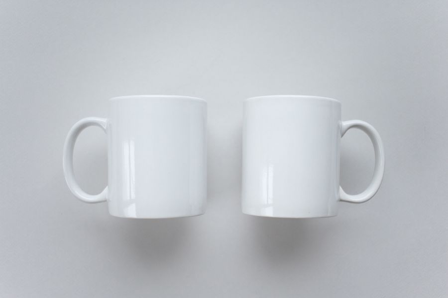 Plain white mugs arranged on a surface