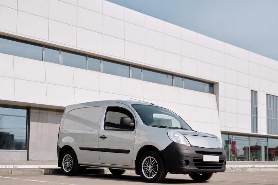 A plain white van photographed from the side